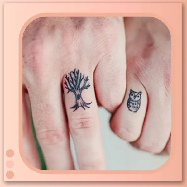 tatuagem de coruja e árvore nos dedos do casal